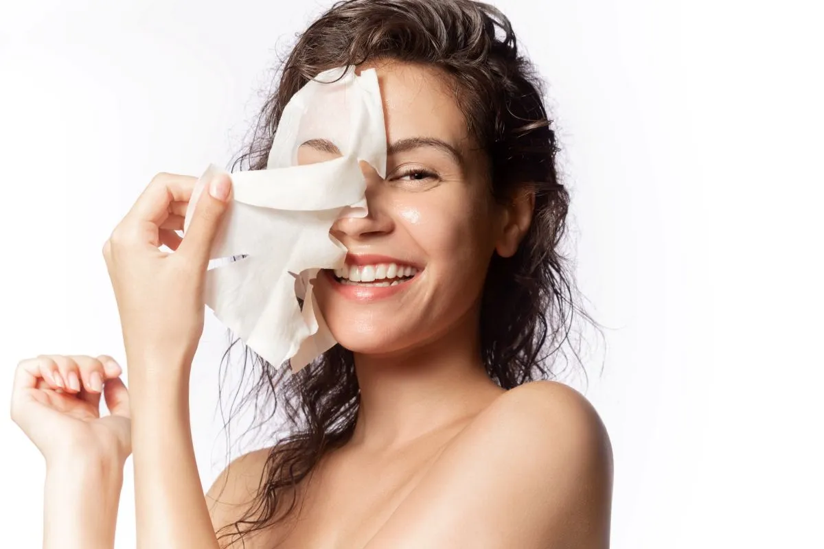 woman peels of face mask